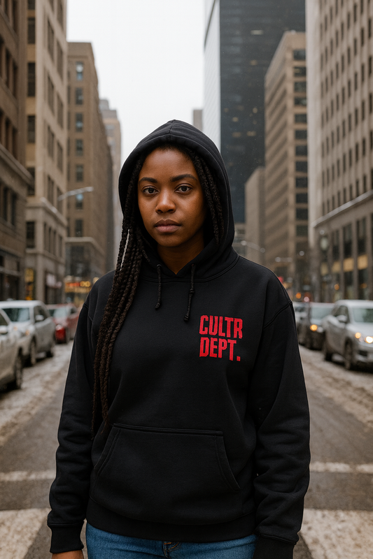 Person wearing a black hoodie with 'CULTR DEPT.' text in red on a city street.