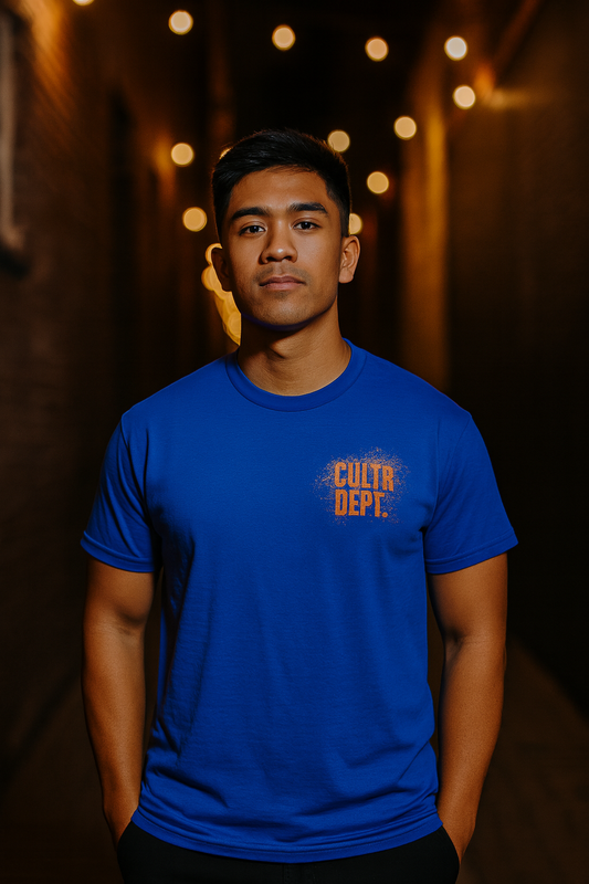 Person wearing a blue t-shirt with 'Cultr Dept' logo against a warm-toned background