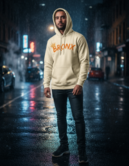 Person wearing a hoodie with 'Bronx' text on a city street at night